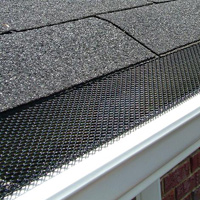 Closeup photo of gutter guards installed on a gutter system to keep gutters clean