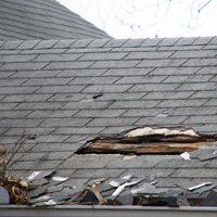 Photo of a roof that has suffered storm damage and needs a major repair
